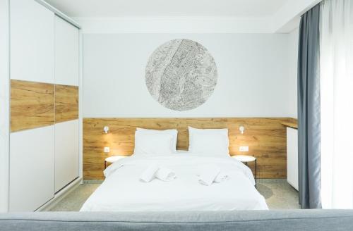a bedroom with a white bed and a large window at Alexandros in Giannitsa