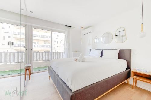 une chambre avec un grand lit et une grande fenêtre dans l'établissement Beautiful apartment close to beaches and palaces, à Cannes