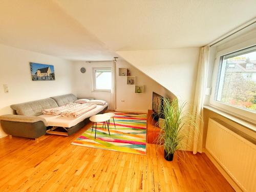 a living room with a couch and a rug at Ferienwohnung Schweinfurt in Schweinfurt