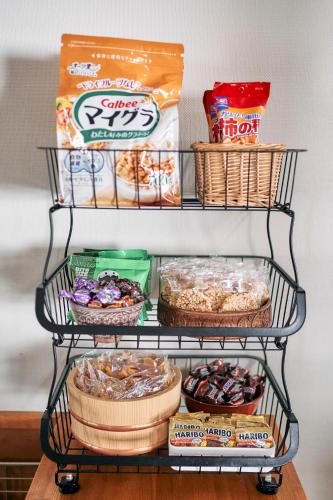 a shelf with some food and snacks on it at Mominoki Lodgeモミの木ロッジ in Minakami