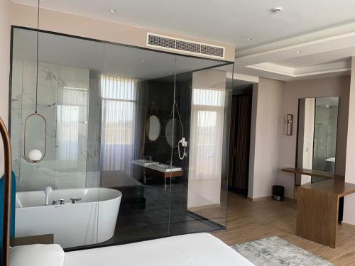 a large bathroom with a tub and a sink at Hotel Vila Aleksander 1 in Shijak