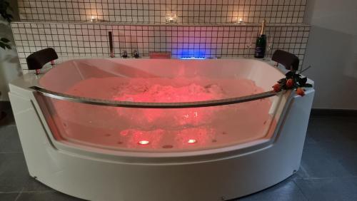 a pink bath tub filled with red liquid at Pension Rondel in Poděbrady