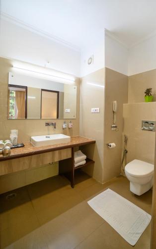 a bathroom with a sink and a toilet at Sinclairs Gangtok in Gangtok
