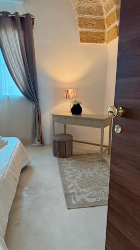 a bedroom with a desk with a cat sitting on it at Casa di Ca Rooms in Squinzano