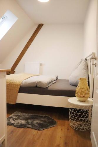 a bedroom with a bed in a attic at Ferienwohnungen Kutschenmeyer in Schneverdingen