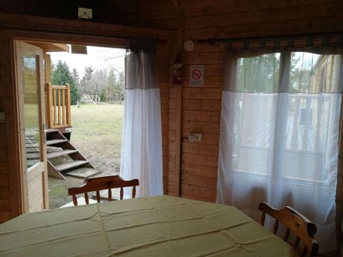 a room with a table and two chairs and a window at La Roulotte du Parc in Saint-Priest-des-Champs