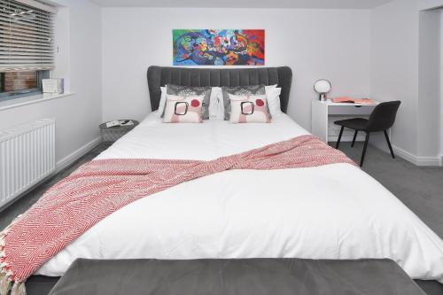 a bedroom with a large bed with two hello kitty pillows at Townhouse @ Aboyne Close Birmingham in Birmingham
