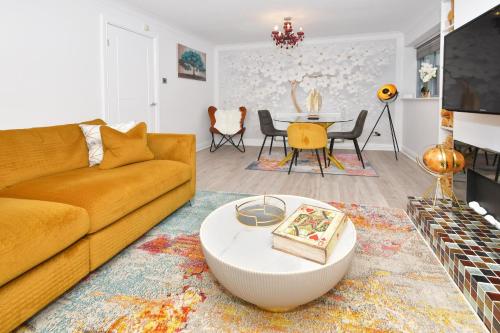 a living room with a couch and a table at Townhouse @ Aboyne Close Birmingham in Birmingham