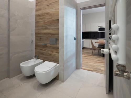 a bathroom with a toilet and a sink at Novos Luxury Suites in Bucharest