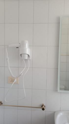 a bathroom with a blow dryer on the wall at Vila Montecelos in Antas de Ulla
