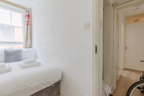 a bedroom with a white bed and a window at Central 1BD Flat 6 minutes to Old Street station in London