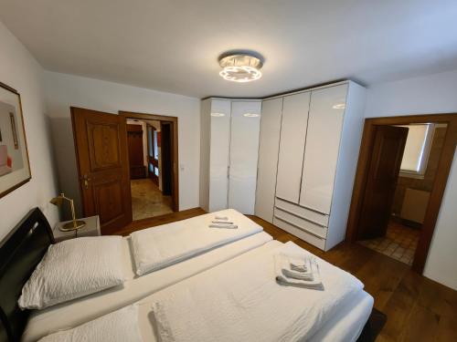 a bedroom with a large white bed in a room at Thurners Dependance in Bruck an der Großglocknerstraße