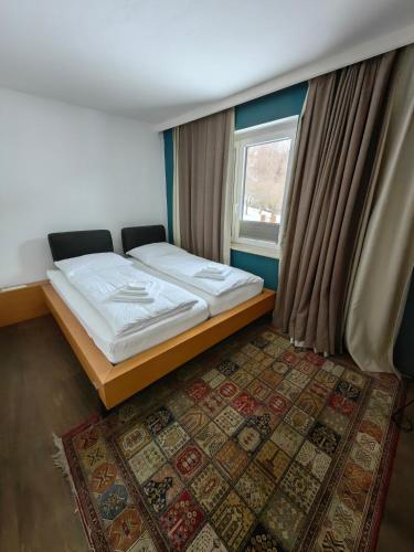 a small bedroom with a bed and a window at Thurners Dependance in Bruck an der Großglocknerstraße