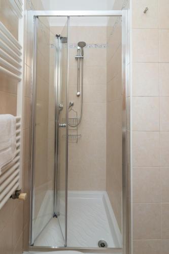 a shower with a glass door in a bathroom at Casa Lulù in Chioggia