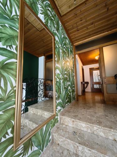 a mirror on the side of a house with a staircase at Thurners Dependance in Bruck an der Großglocknerstraße