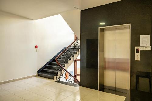 a hallway with a staircase in a building at Hùng Phong Hotel - Near Dalat Market in Da Lat