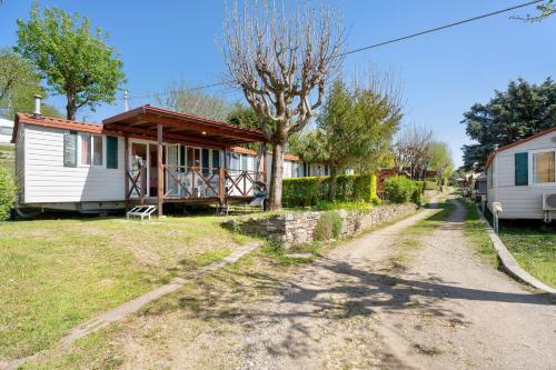 a house on a dirt road in front of a house at Camping Royal in Pettenasco