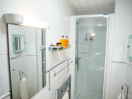 a bathroom with a shower and a glass shower backdoor at Briardene Hotel in Blackpool