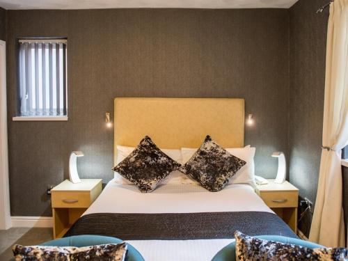 a bedroom with a bed with two pillows on it at Briardene Hotel in Blackpool