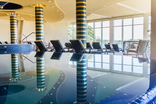 a waiting room with chairs and columns in a building at Vitalia Seehotel in Bad Segeberg