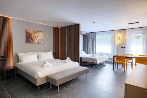 a hotel room with a bed and a dining room at Isabella Suites in Il-Gżira