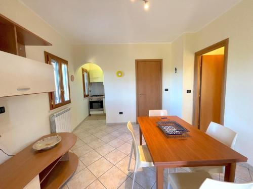a kitchen and dining room with a wooden table at Salapia House in San Cataldo