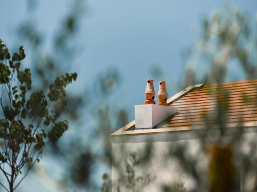 a house with two chimneys on the roof at Viceroy at Ombria Algarve in Loulé