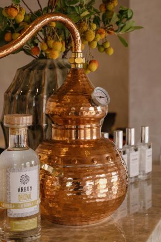 a bottle of alcohol sitting next to a vase of grapes at Viceroy at Ombria Algarve in Loulé