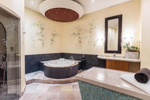 a large bathroom with a tub and a sink at Vitalia Seehotel in Bad Segeberg