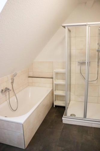 a bathroom with a shower and a bath tub at Ferienwohnungen Kutschenmeyer in Schneverdingen