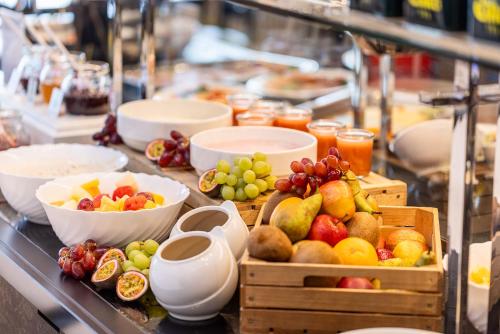 a buffet with fruits and other foods on a table at Vitalia Seehotel in Bad Segeberg