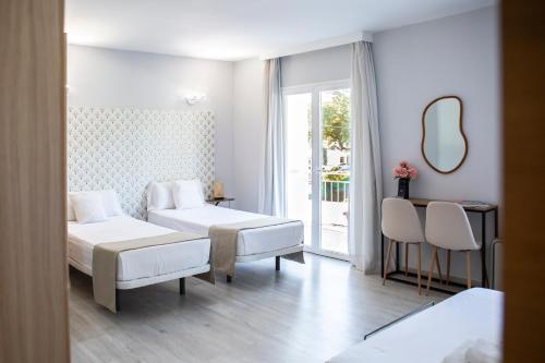 Postel nebo postele na pokoji v ubytování Hotel Casa Dalia