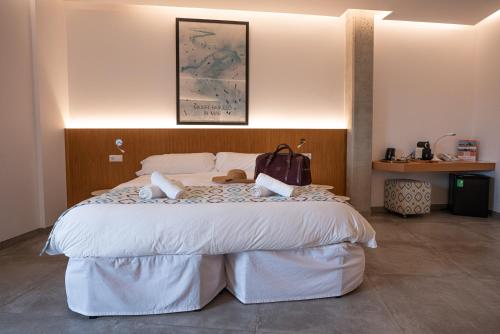 a bedroom with a large bed with a purse on it at Finca Agroturismo Son Menut in Felanitx