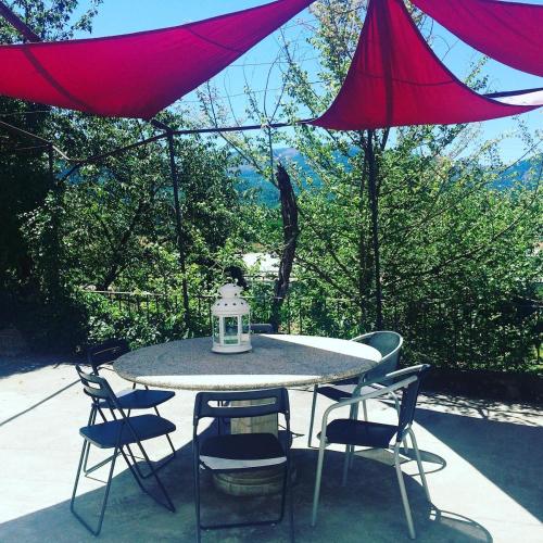 a table and chairs with a lantern on a patio at Casa Histórica entre las Montañas in Quiroga