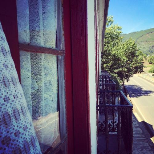 an open window with a view of a balcony at Casa Histórica entre las Montañas in Quiroga