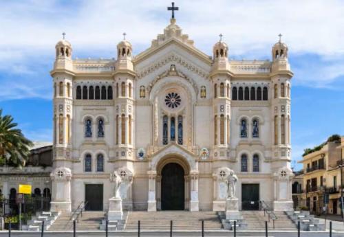 a large white church with stairs in front of it at ToMa House in Pellaro