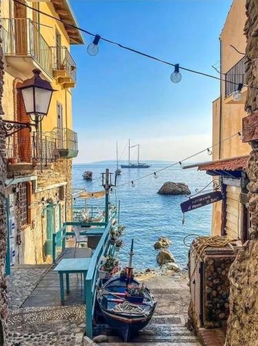 a view of the ocean from between two buildings at ToMa House in Pellaro