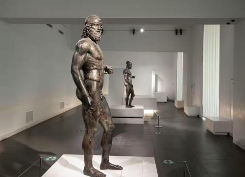a statue of a man in a museum exhibit at ToMa House in Pellaro