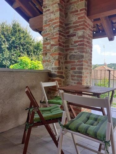 two chairs and a table on a patio at La Carpa e la Calendula - Appartamenti Vacanze in Niella Tanaro