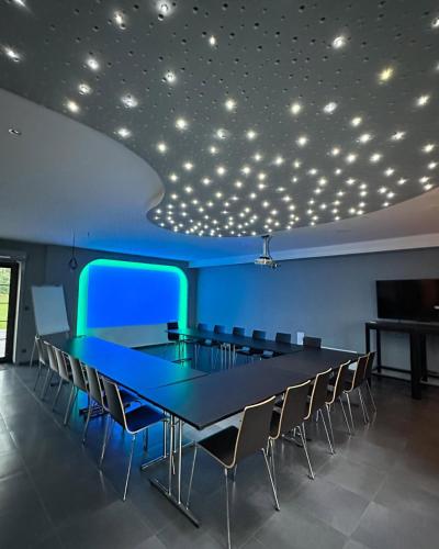 a conference room with a long table and chairs at Penzion Black Hole in Provodín