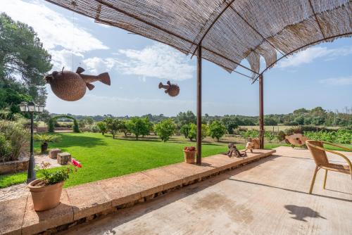 an outdoor patio with a view of a park at Finca Agroturismo Son Menut in Felanitx