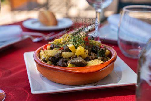 a bowl of food on a plate on a table at Finca Agroturismo Son Menut in Felanitx
