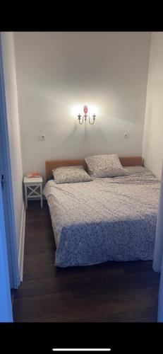 une chambre avec un lit et une lumière sur le mur dans l'établissement Beautiful Flat Champs-Elysée, à Paris