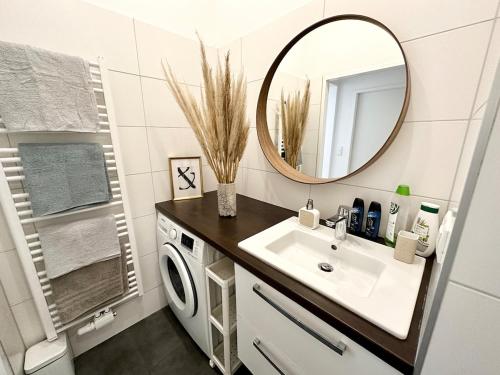a bathroom with a sink and a washing machine at Panda Apartment in Vienna