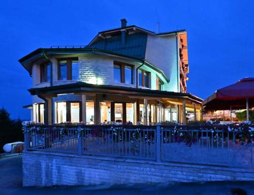 a large house with a fence in front of it at IN Hotel Zlatar ex Zlatarski Biseri in Nova Varoš