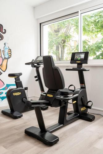 a room with three exercise bikes and a computer at Hotel Mediterraneo in Riccione