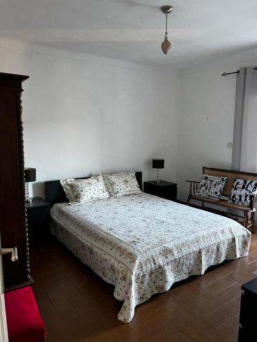 a bedroom with a bed and two chairs in it at Casa Paraíso in Ribeira de Pena