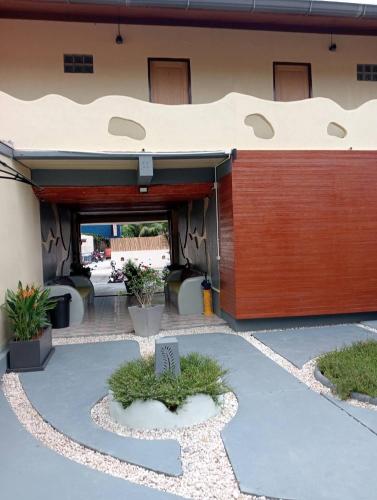 a building with a wooden door and a patio at Pandora Café in Chaweng
