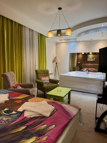 a hotel room with a large bed and a bedroom at Jacuzzi In Bedroom Elegance Apartments in Zlatibor