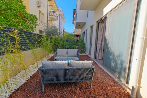 a patio with two couches on the side of a building at Nakas Hotel in Fethiye